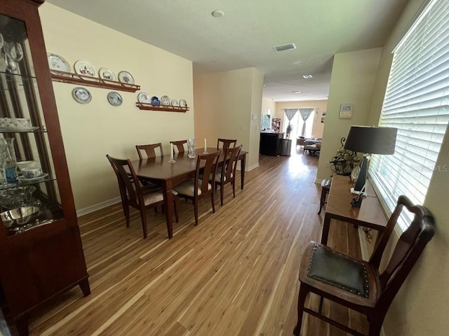 dining space featuring wood-type flooring