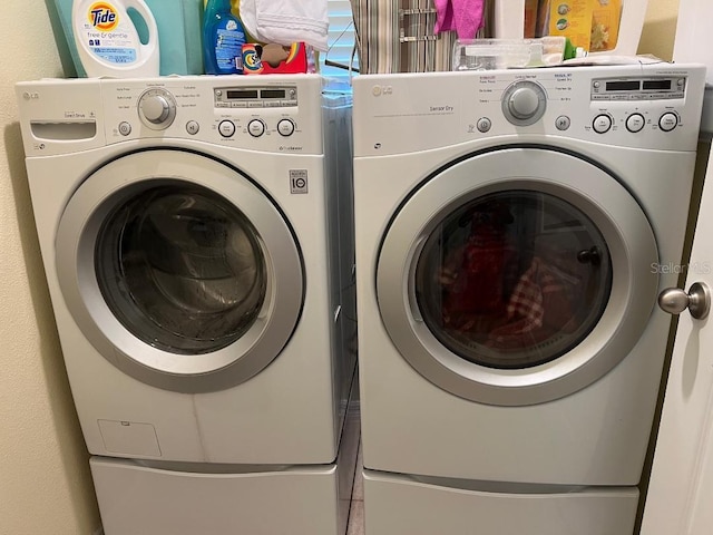 laundry room featuring separate washer and dryer and tile floors