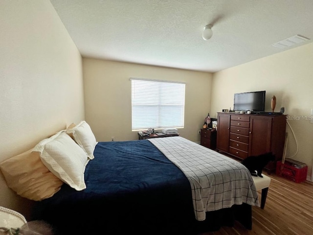 bedroom with dark hardwood / wood-style flooring