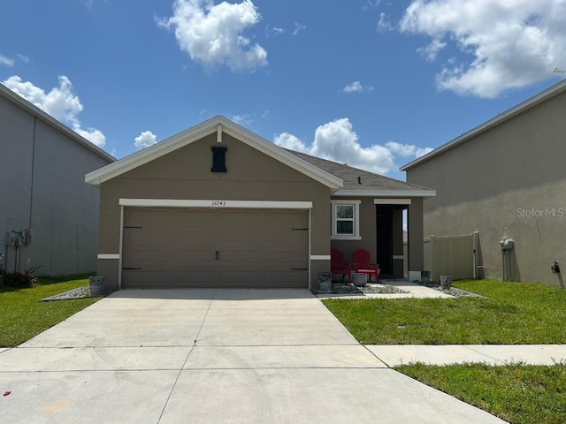 ranch-style house featuring a garage and a front lawn