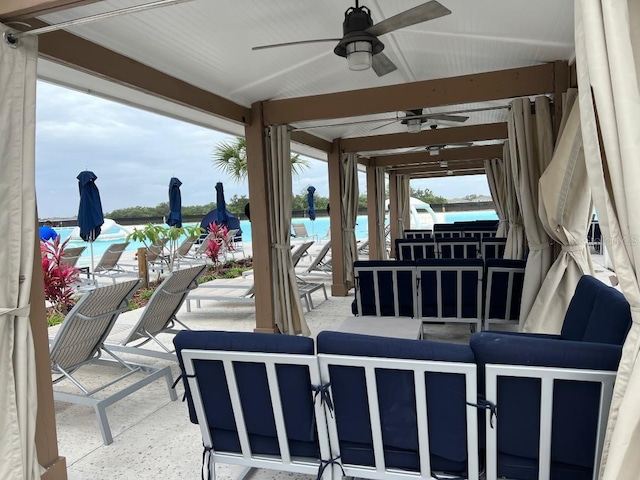 view of terrace with outdoor lounge area, a pool, and ceiling fan