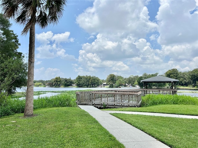 view of home's community with a water view, a yard, and a gazebo