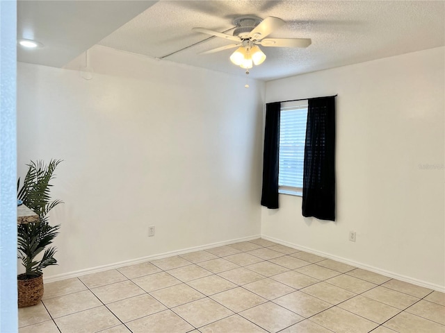 spare room featuring ceiling fan and a textured ceiling