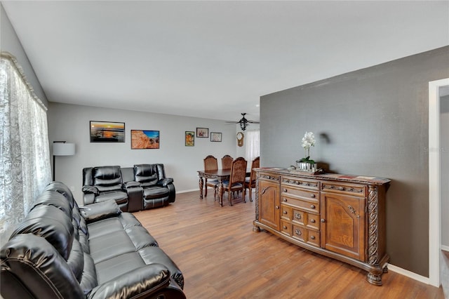 living room featuring light wood-type flooring and ceiling fan