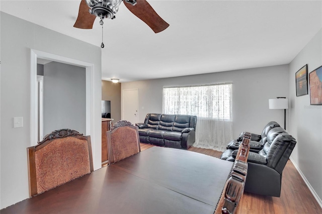 dining room with wood-type flooring and ceiling fan