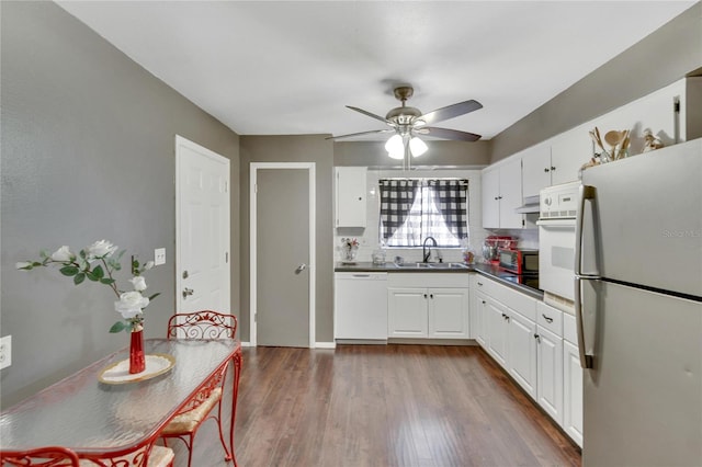 kitchen featuring dark hardwood / wood-style floors, ceiling fan, white cabinets, sink, and white appliances