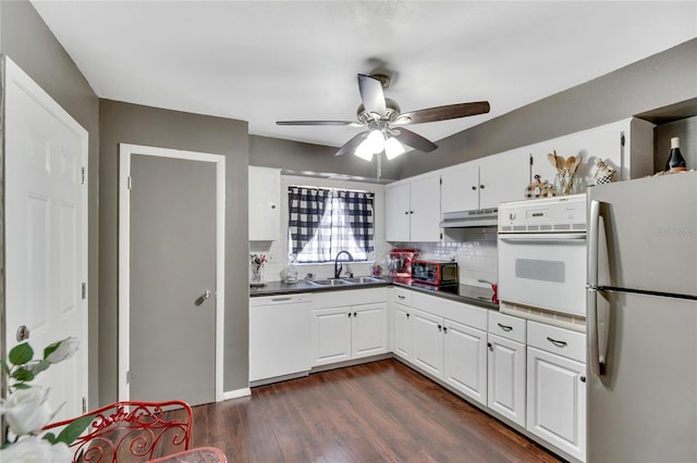 kitchen with ceiling fan, white appliances, dark wood-type flooring, backsplash, and white cabinetry