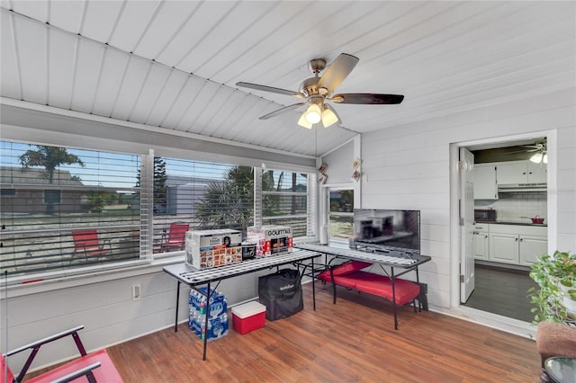 home office with dark wood-type flooring and ceiling fan