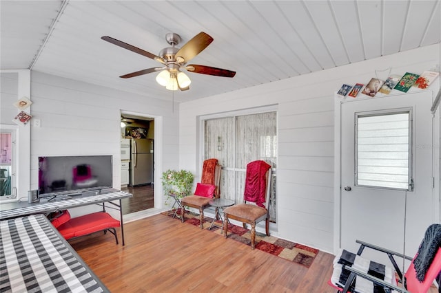 living room with ceiling fan and light hardwood / wood-style floors