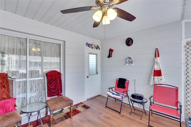 sitting room with hardwood / wood-style flooring and ceiling fan