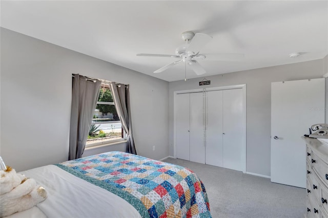 carpeted bedroom featuring a closet and ceiling fan