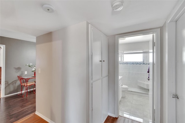 hallway with tile floors and tile walls