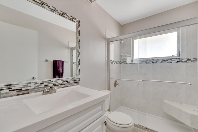 bathroom with an enclosed shower, backsplash, toilet, and vanity