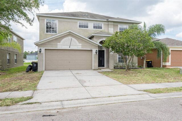 view of front of house featuring a garage and a front yard