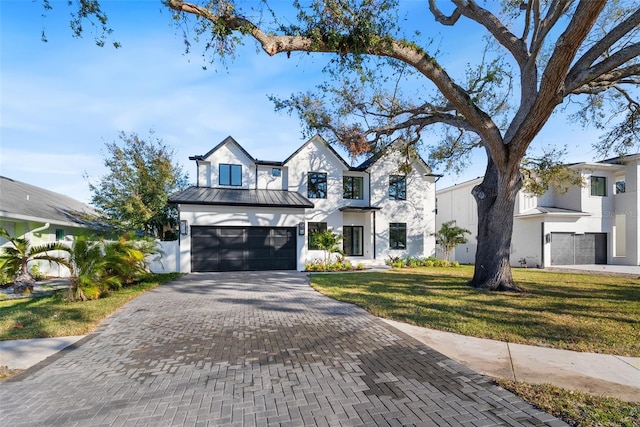 view of front of house featuring a front yard and a garage