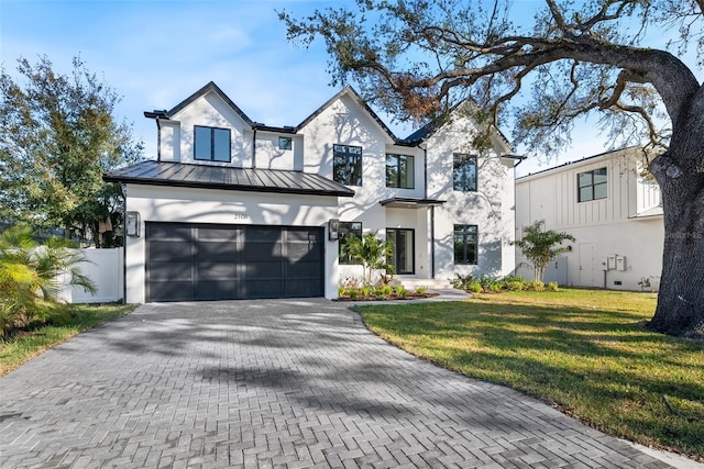 modern farmhouse with a garage and a front lawn