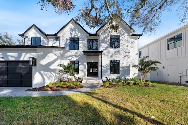 view of front of property with a front yard and a garage