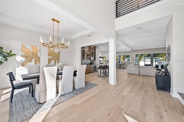 dining area featuring light hardwood / wood-style floors and a notable chandelier