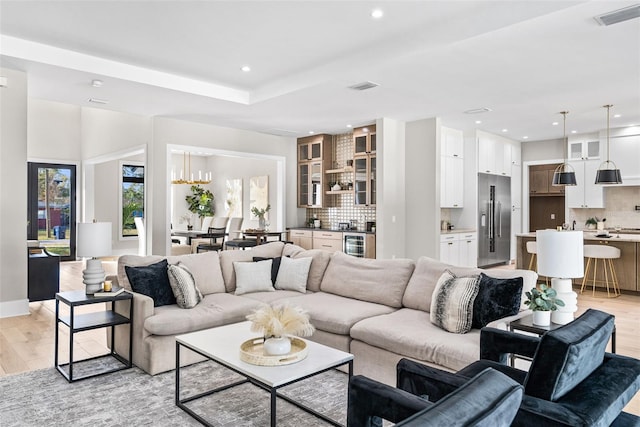 living room with light hardwood / wood-style flooring and wine cooler