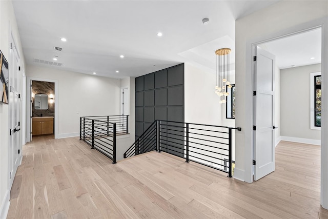 hallway with light hardwood / wood-style floors