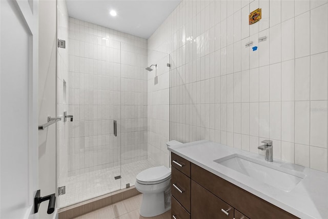 bathroom featuring toilet, walk in shower, tile walls, tile patterned floors, and vanity