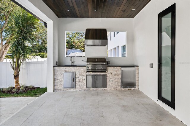 view of patio with sink, a grill, and exterior kitchen