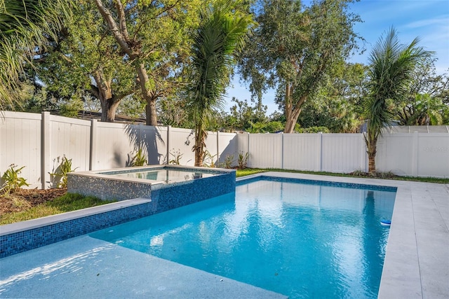 view of swimming pool featuring an in ground hot tub