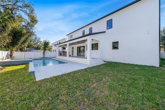 view of swimming pool featuring a patio area and a lawn