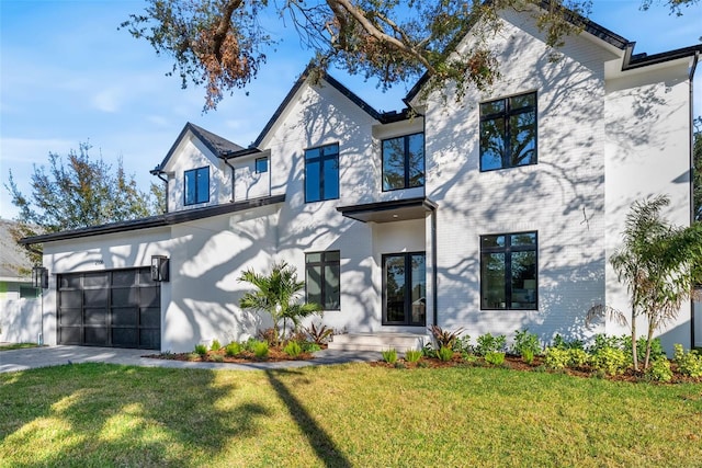 view of front of property with a front yard and a garage