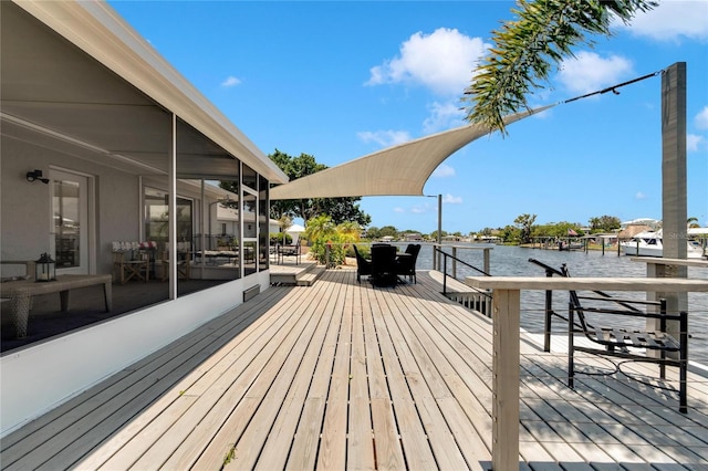 wooden deck featuring a sunroom and a water view