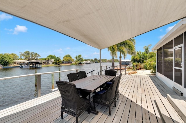 wooden terrace with a water view and a sunroom