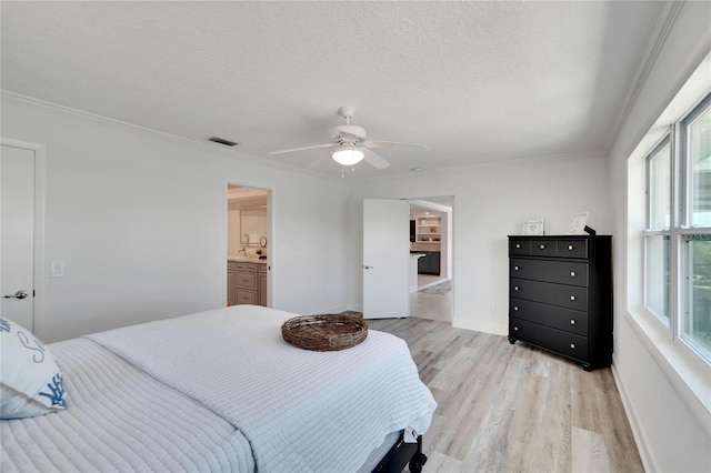 bedroom with a textured ceiling, light hardwood / wood-style flooring, ceiling fan, and ornamental molding