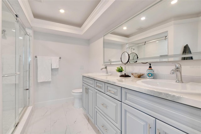 bathroom with a tray ceiling, vanity, ornamental molding, and toilet