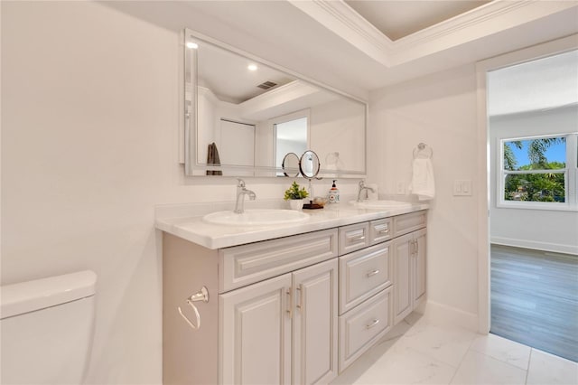 bathroom with crown molding, hardwood / wood-style floors, vanity, and toilet