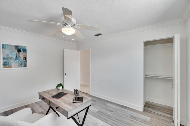 office with crown molding, ceiling fan, light hardwood / wood-style floors, and a textured ceiling