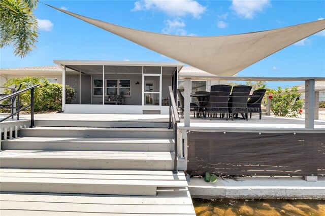 back of house featuring a sunroom