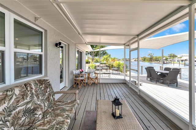 wooden terrace featuring a water view