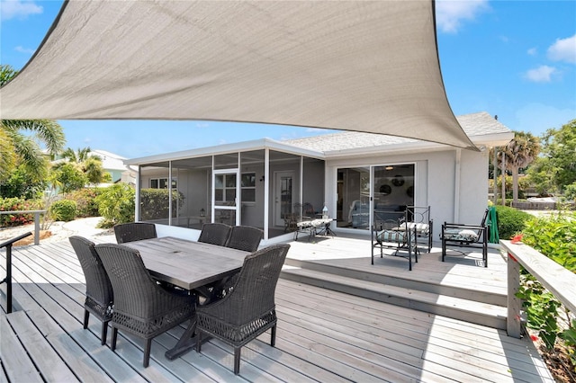 wooden deck with a sunroom