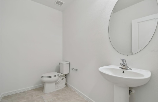 bathroom featuring tile patterned flooring and toilet