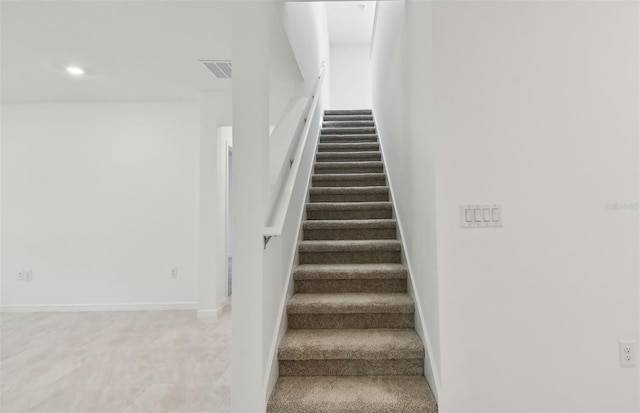 stairs featuring carpet