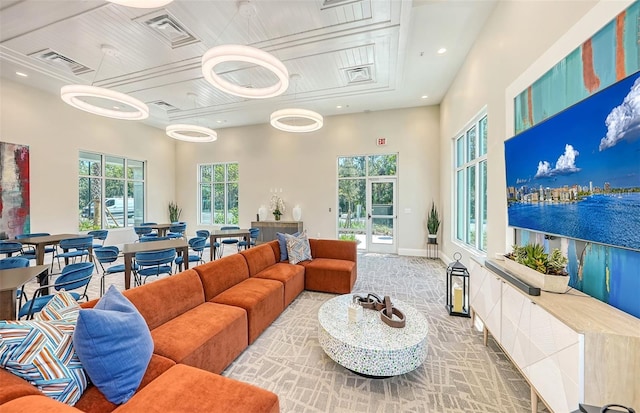 living room featuring a towering ceiling