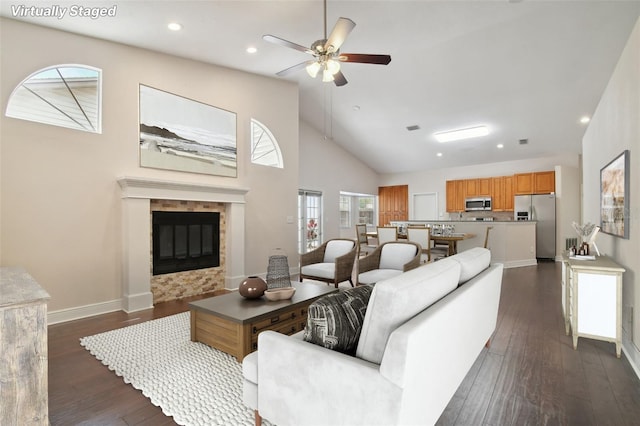 living room with dark hardwood / wood-style flooring, high vaulted ceiling, and ceiling fan