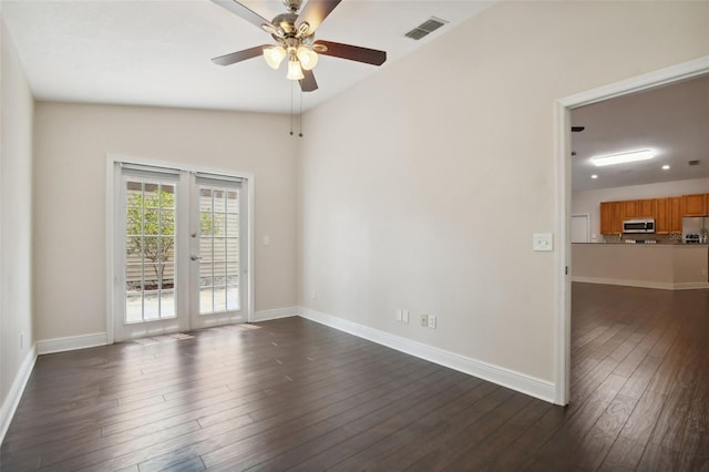 spare room with french doors, lofted ceiling, ceiling fan, and dark wood-type flooring