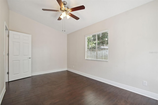 empty room with ceiling fan and dark wood-type flooring