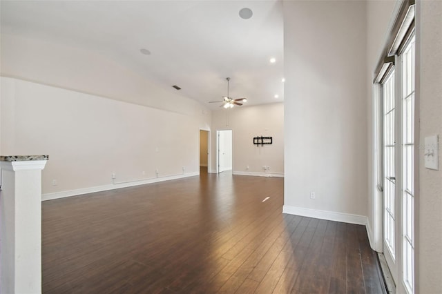 empty room featuring ceiling fan, dark wood-type flooring, and vaulted ceiling