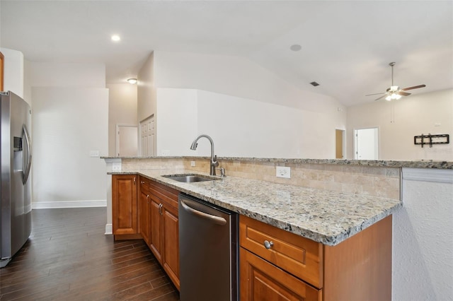 kitchen with light stone countertops, sink, stainless steel appliances, dark hardwood / wood-style flooring, and decorative backsplash