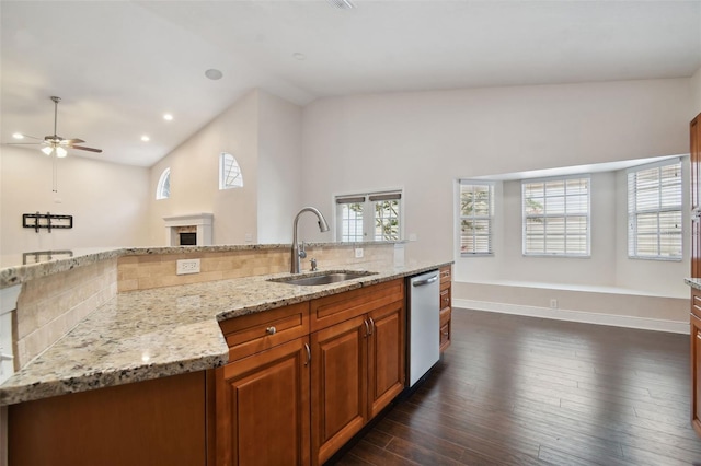 kitchen with stainless steel dishwasher, decorative backsplash, a healthy amount of sunlight, and sink