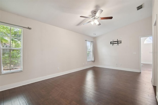 empty room with ceiling fan, dark hardwood / wood-style flooring, and lofted ceiling