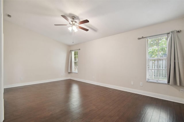 empty room featuring dark hardwood / wood-style floors, plenty of natural light, and ceiling fan