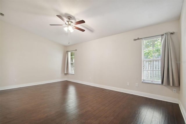 unfurnished room with dark wood-type flooring, ceiling fan, and a healthy amount of sunlight